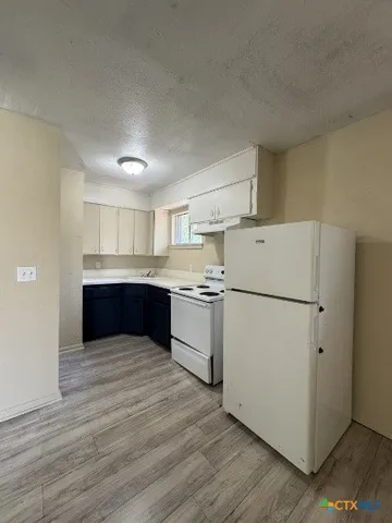 a view of kitchen with wooden floor