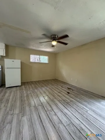 a view of an empty room and a window