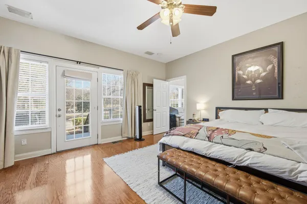 a bedroom with a large bed and a large window