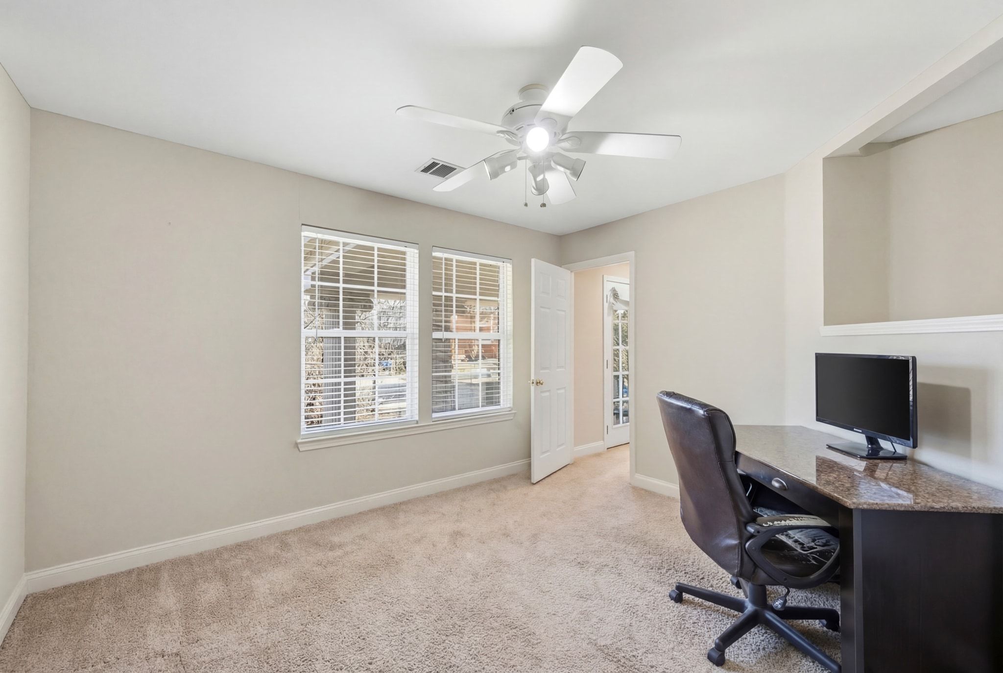 2413 Enfield Road Austin, TX 78703 - Photo 19 of 38 a view of a workspace with furniture and a window