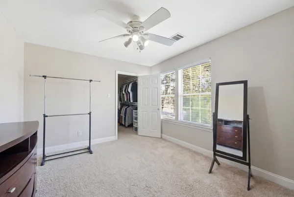 a view of livingroom with furniture cabinet ceiling fan and window