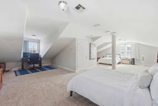 a large white bed in a white room