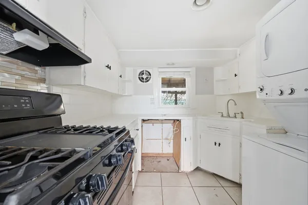 a kitchen with stainless steel appliances a sink a stove and cabinets