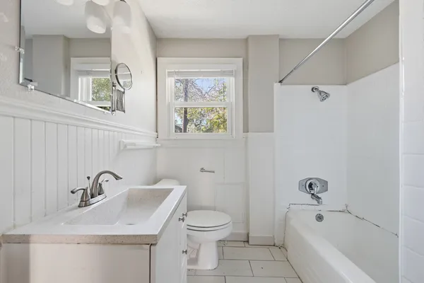 a bathroom with a sink a toilet and a bathtub