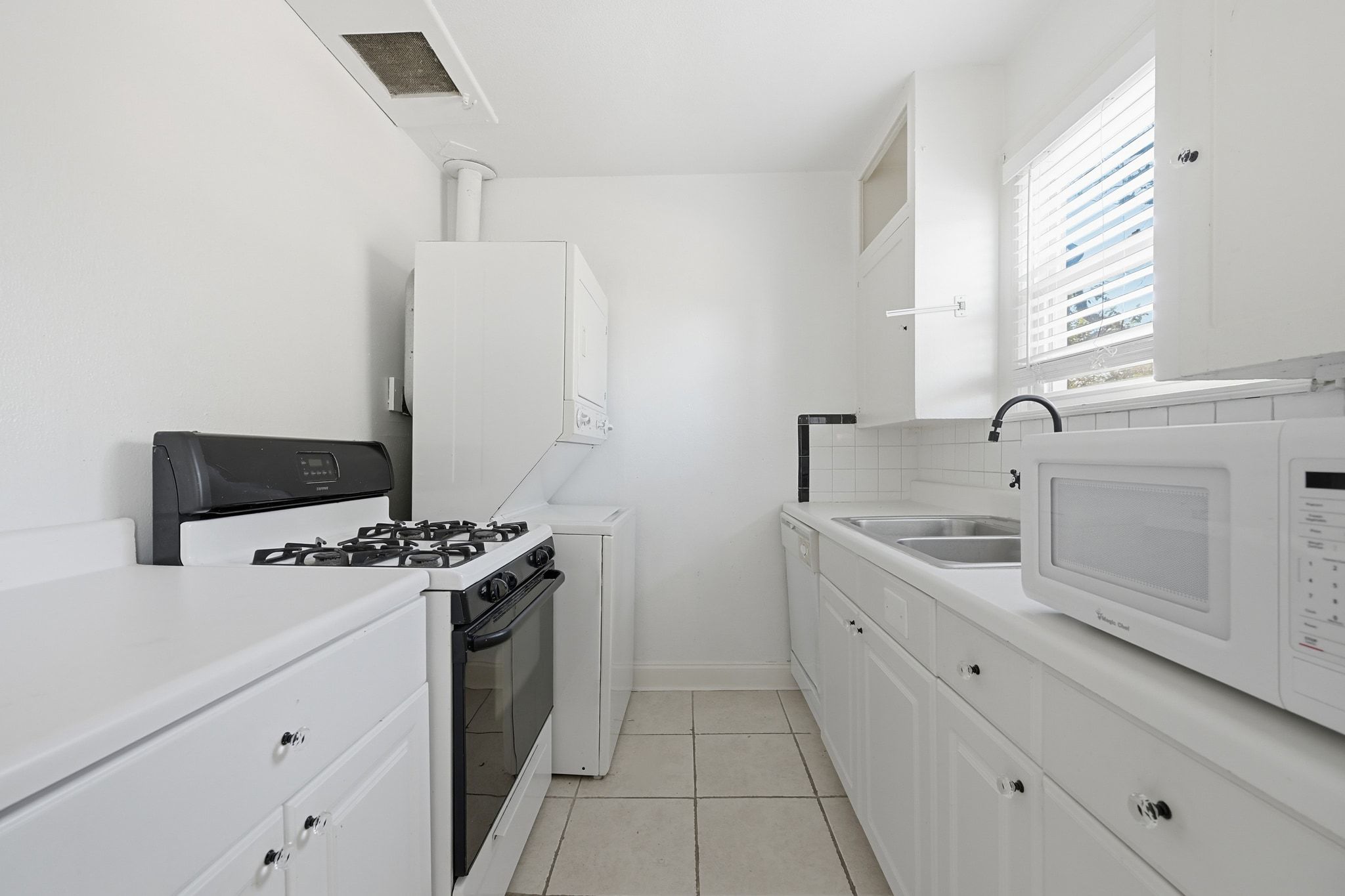 2413 Enfield Road Austin, TX 78703 - Photo 35 of 38 a kitchen with a stove and a sink