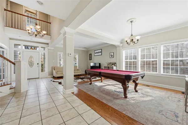 a living room with furniture a table and a large window