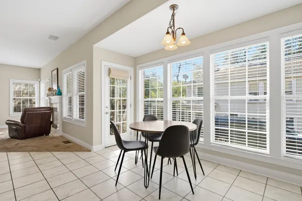 a view of a dining room with furniture windows and wooden floor