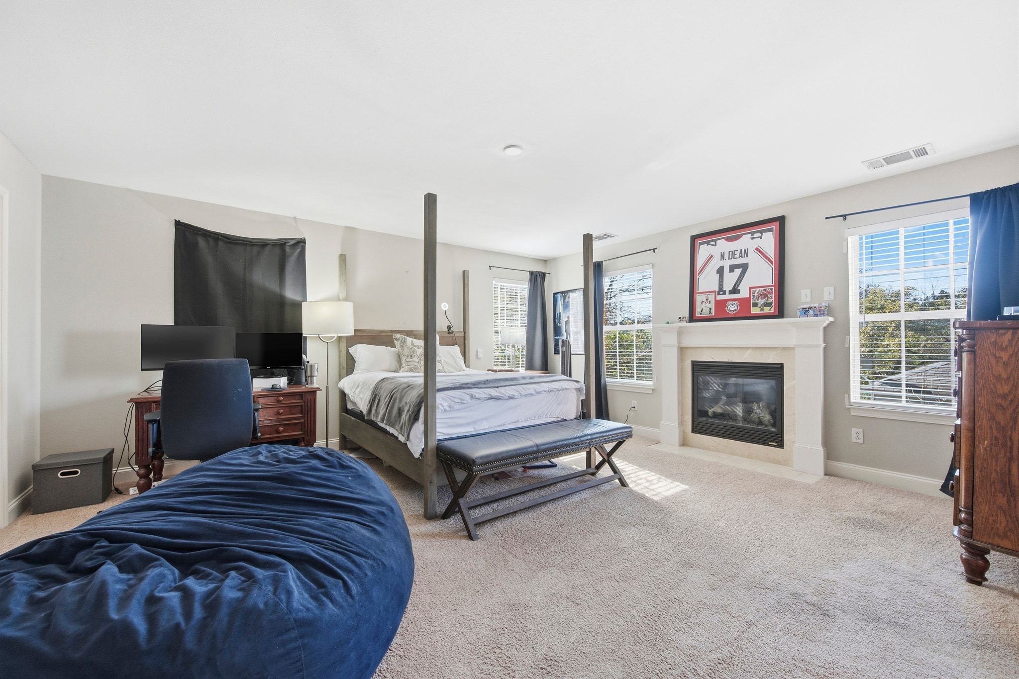 2413 Enfield Road Austin, TX 78703 - Photo 10 of 38 a spacious bedroom with a bed a fireplace and a television