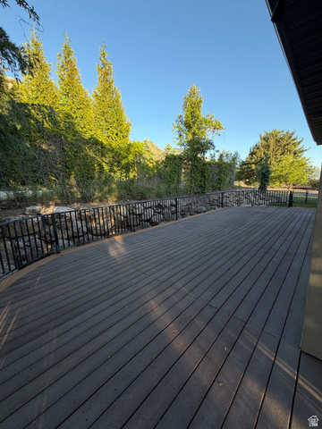 4536 North 475 East Provo, UT 84604 - Photo 54 of 65 Expansive composite deck featuring a black metal railing and a stone retaining wall