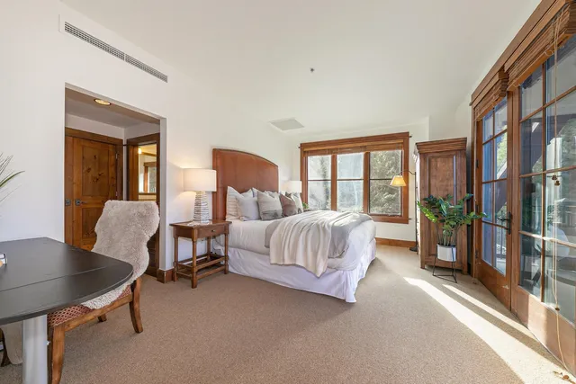 a bedroom with furniture and a large window