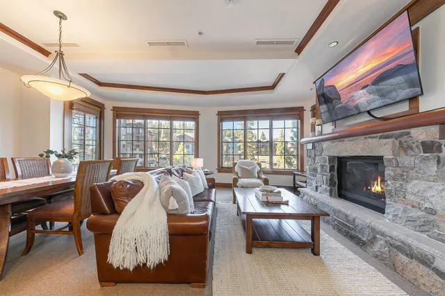 a living room with furniture fireplace and a large window