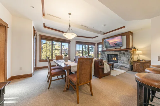 a living room with furniture a fireplace and a table