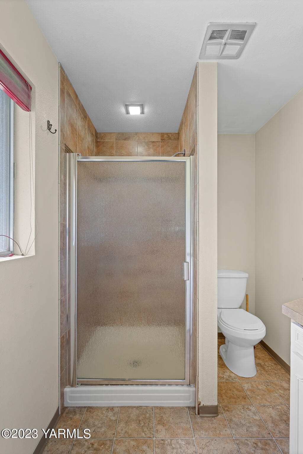 9206 Occidental Road Yakima, WA 98903 - Photo 12 of 23 a bathroom with a toilet and a shower