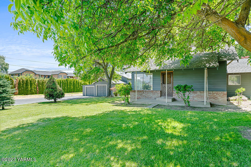 9206 Occidental Road Yakima, WA 98903 - Photo 2 of 23 a front view of a house with a yard and a garden