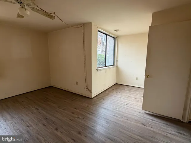 a view of a room with wooden floor and white walls