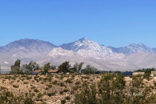 237 North Alford Street Ridgecrest, CA 93555 - Photo 31 of 35 a view of a dry yard with mountains in the background