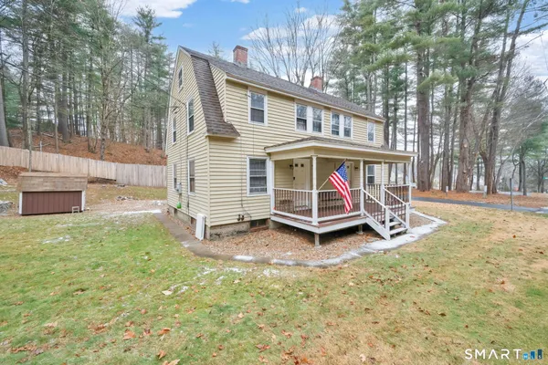 a view of a house with backyard porch and sitting area