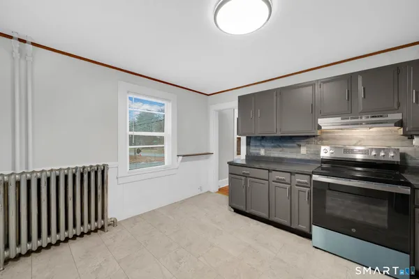 a kitchen with stainless steel appliances granite countertop a stove and a sink