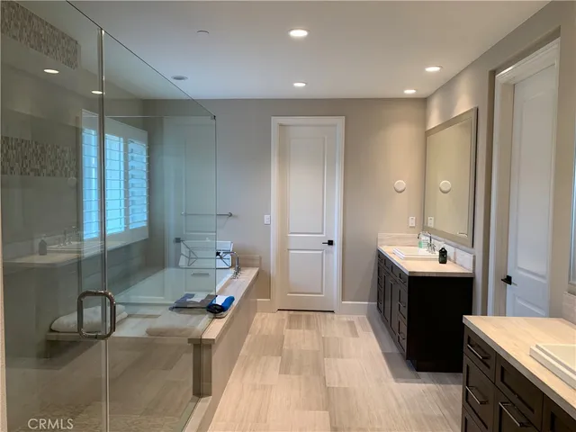 a bathroom with a double vanity sink and mirror