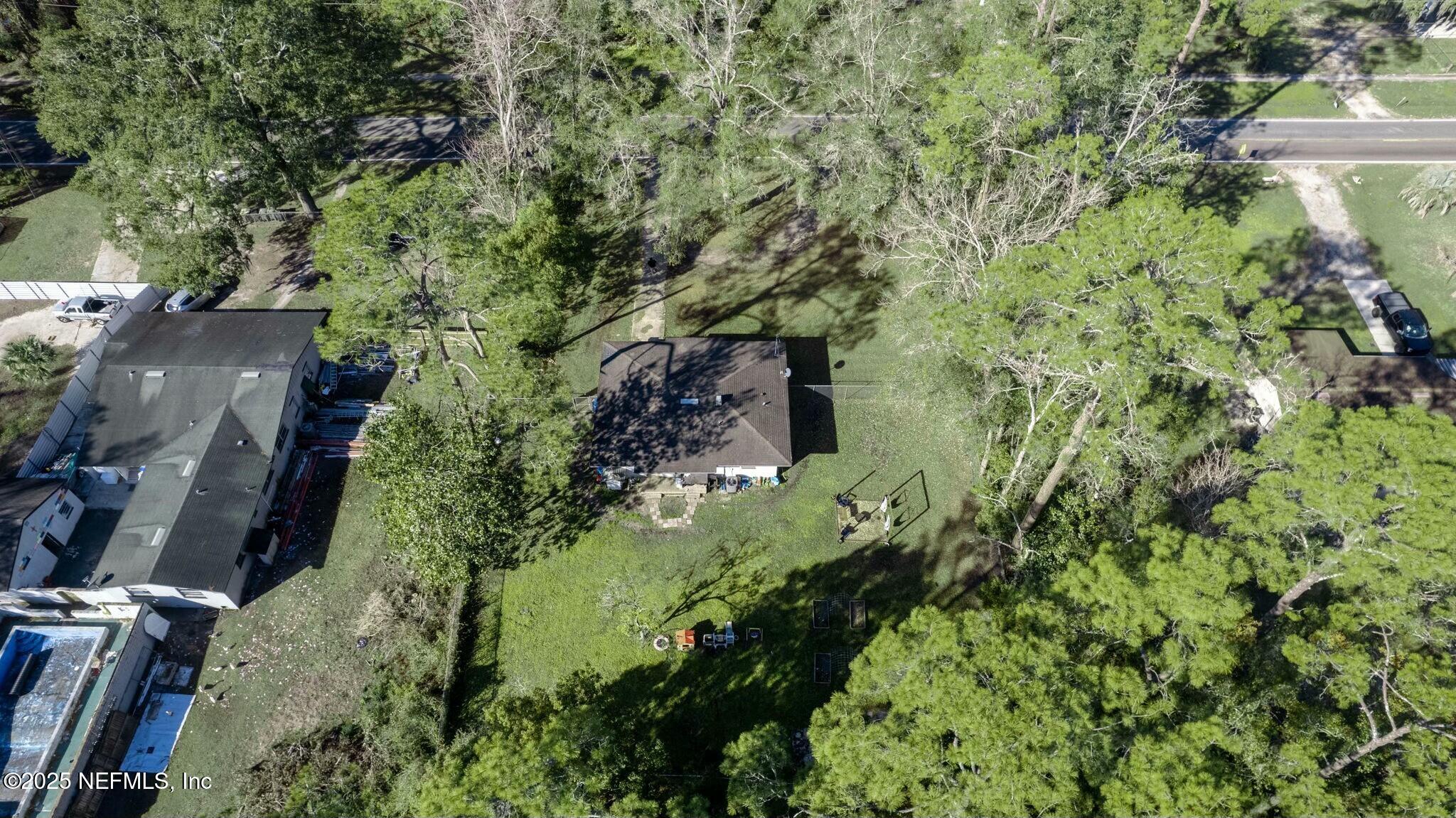6053 Firestone Road Jacksonville, FL 32244 - Photo 31 of 34 an aerial view of residential house with outdoor space and trees all around