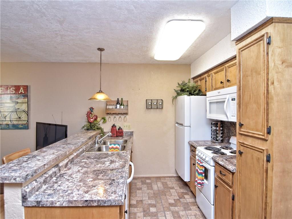 910 Duncan Lane, Unit 2 Austin, TX 78705 - Photo 3 of 11 Functional kitchen with ample counter space and integrated breakfast bar for casual dining.