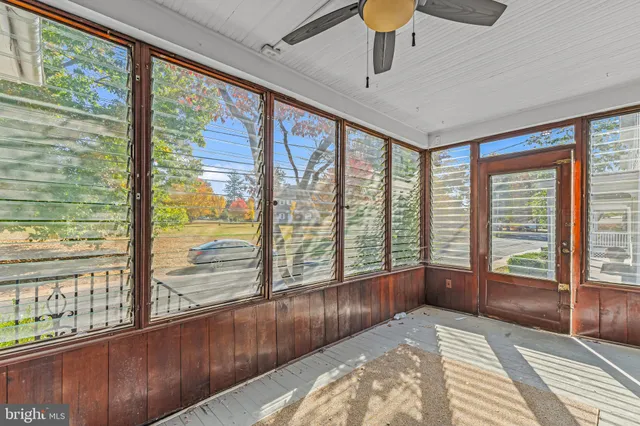 a bedroom with furniture and large windows