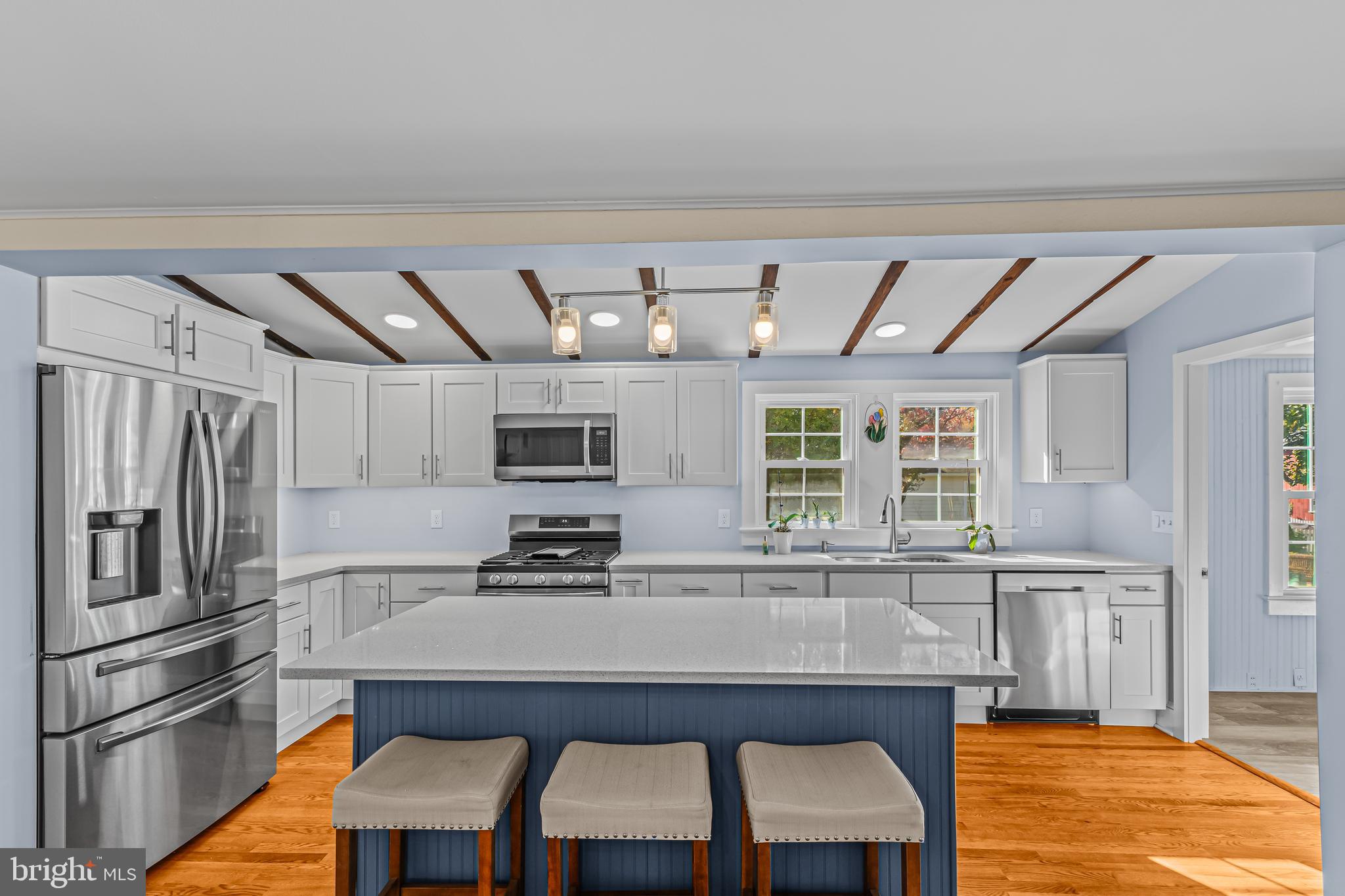14 Church Street Chesterfield, NJ 08515 - Photo 10 of 25 a kitchen with stainless steel appliances granite countertop a stove a refrigerator a sink dishwasher a dining table and chairs with wooden floor