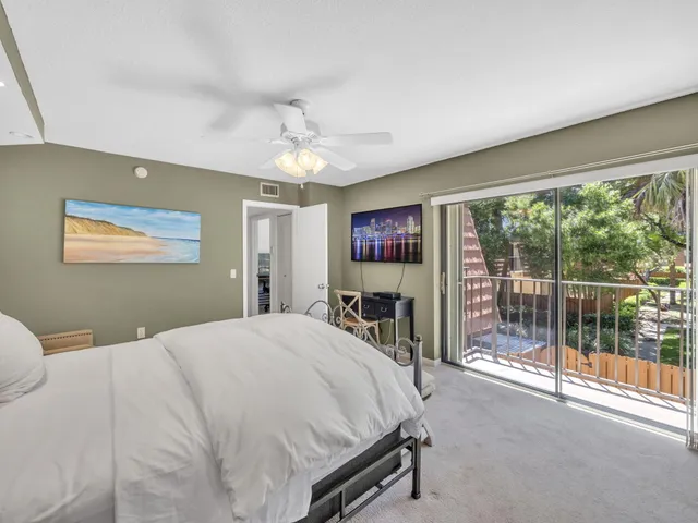 a spacious bedroom with a bed and a table