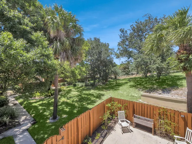 a view of a wooden deck with trees in the background