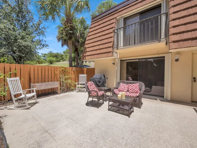 a building outdoor space with patio furniture and potted plants