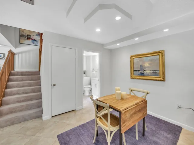 a dining room with a furniture and wooden floor