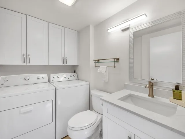 a view of bathroom with a washer and dryer