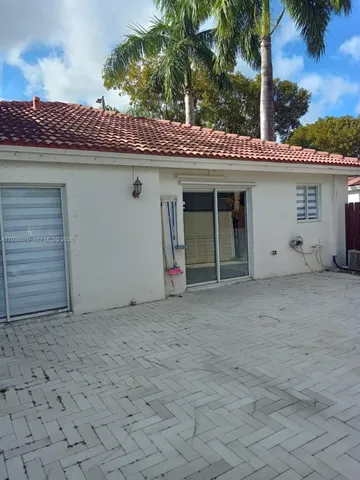 a view of a house with a small yard and a garage