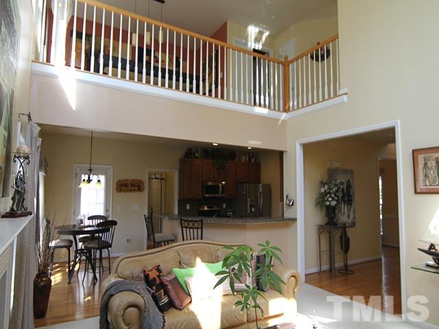 1505 Autumn Ridge Drive Durham, NC 27712 - Photo 11 of 25 a hallway with a couch a dining table and chairs