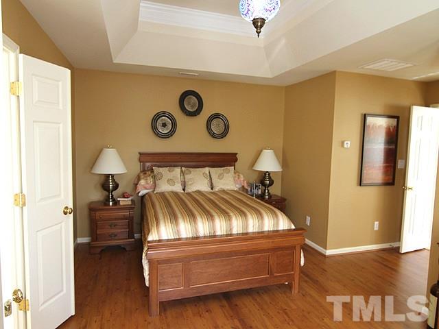 1505 Autumn Ridge Drive Durham, NC 27712 - Photo 13 of 25 a bedroom with a bed and wooden floor