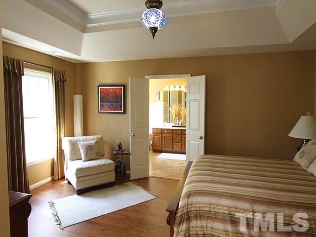 1505 Autumn Ridge Drive Durham, NC 27712 - Photo 14 of 25 a bedroom with a bed a couch and a window