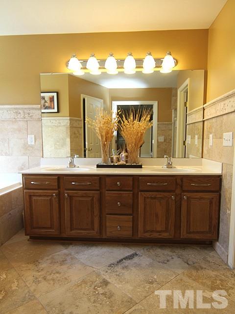 1505 Autumn Ridge Drive Durham, NC 27712 - Photo 15 of 25 a bathroom with a granite countertop sink and a large mirror