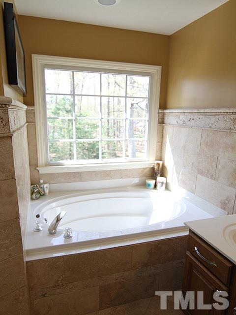 1505 Autumn Ridge Drive Durham, NC 27712 - Photo 16 of 25 a bathroom with a bathtub and a sink