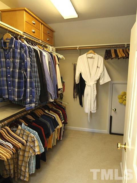 1505 Autumn Ridge Drive Durham, NC 27712 - Photo 18 of 25 a view of walk in closet with clothes and shoes