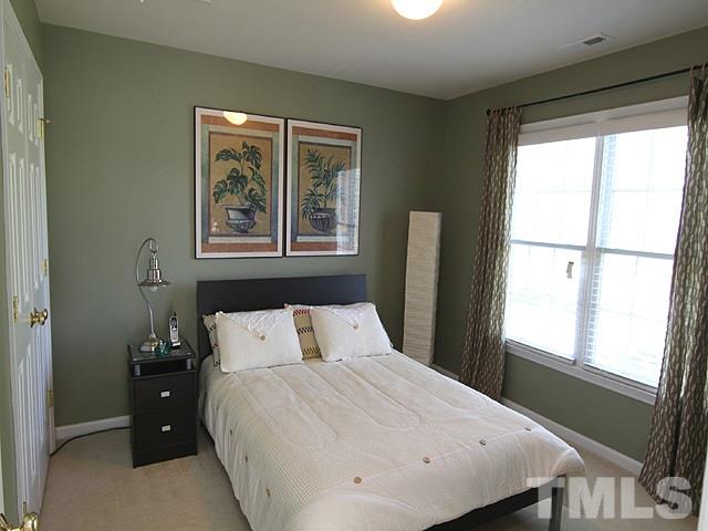 1505 Autumn Ridge Drive Durham, NC 27712 - Photo 19 of 25 a bedroom with a large bed and a window