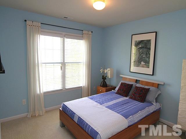 1505 Autumn Ridge Drive Durham, NC 27712 - Photo 21 of 25 a bedroom with a bed and window