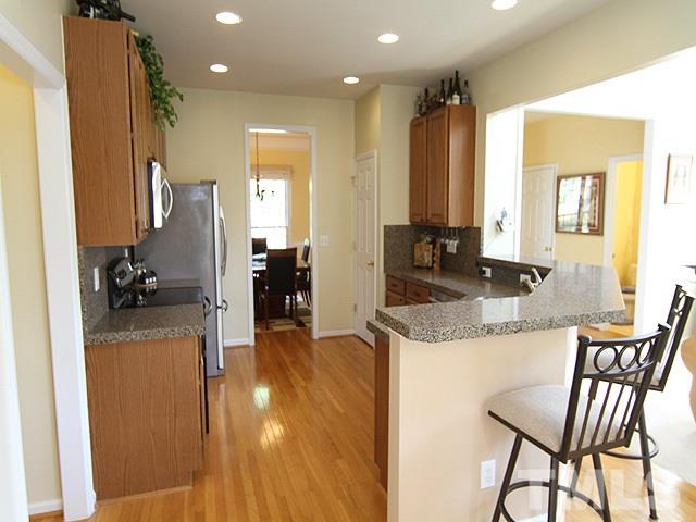 1505 Autumn Ridge Drive Durham, NC 27712 - Photo 5 of 25 a kitchen with a table chairs refrigerator and sink