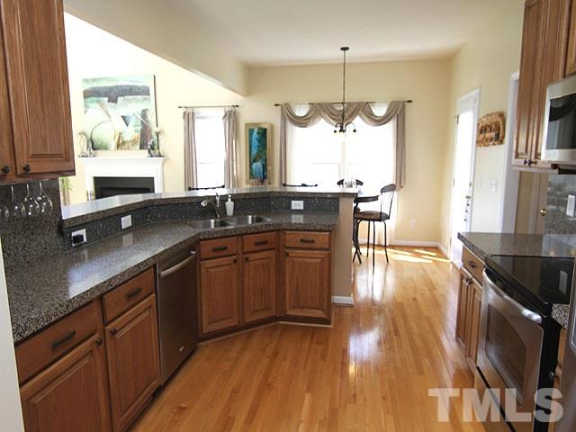 1505 Autumn Ridge Drive Durham, NC 27712 - Photo 7 of 25 a kitchen with a sink and wooden floor