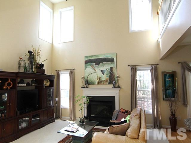 1505 Autumn Ridge Drive Durham, NC 27712 - Photo 9 of 25 a living room with furniture a flat screen tv and a fireplace