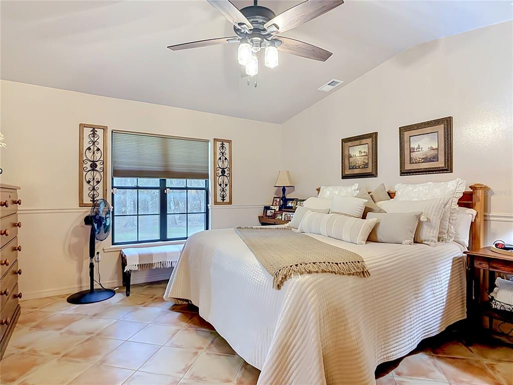 1395 Maytown Road Osteen, FL 32764 - Photo 31 of 65 a bed room with a bed and a couch