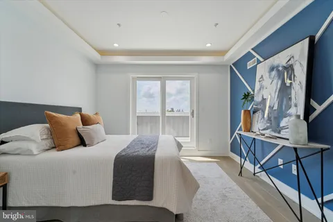 a bedroom with a large bed and a flat tv screen on a dresser