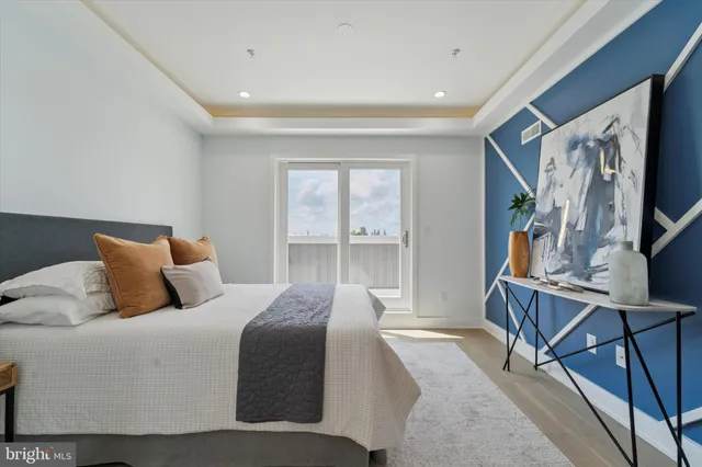 a bedroom with a large bed and a flat tv screen on a dresser