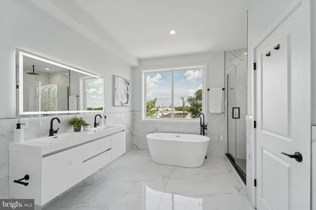 a en suite bathroom with a tub sink and mirror