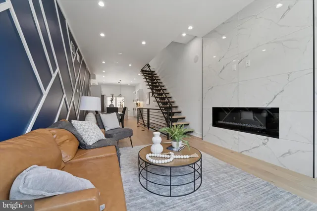a living room with furniture and a fireplace