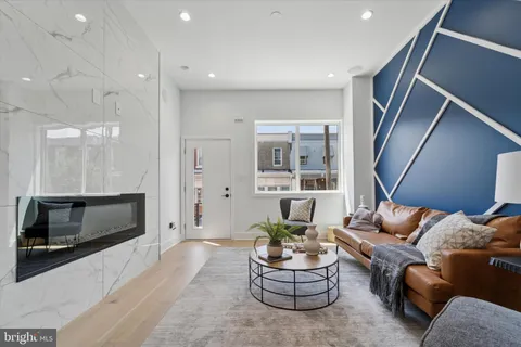 a living room with furniture kitchen and a fireplace